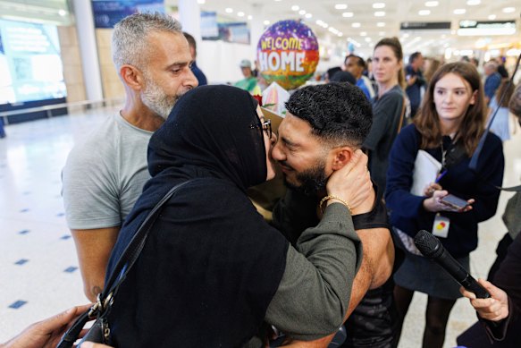 Imam Keryam embraces her son Youssef  after arriving in Sydney, after five days stranded in the Middle East. 