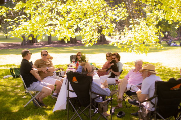 Angie Manly and her friends enjoy a picnic in Fitzroy Gardens.