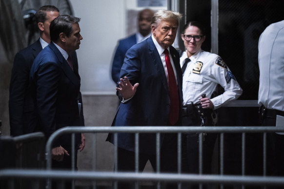 Former President Donald Trump walks back into the courtroom following a break at the Manhattan Criminal Court ahead of jury selection in New York.