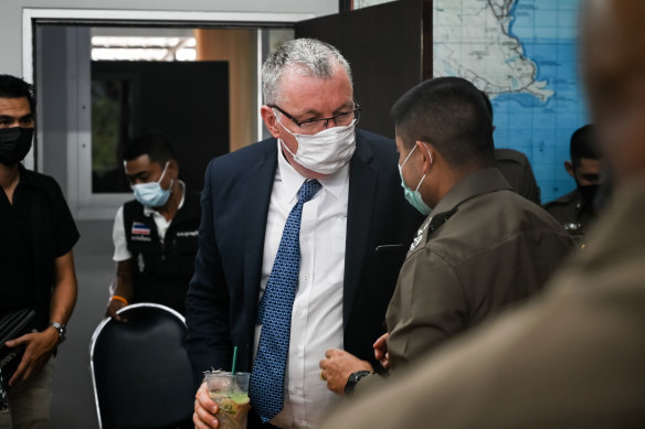 Australian Ambassador to Thailand Allan McKinnon (centre) attends a press conference at the Bophut Police Station on Monday, March 7, 2022. 