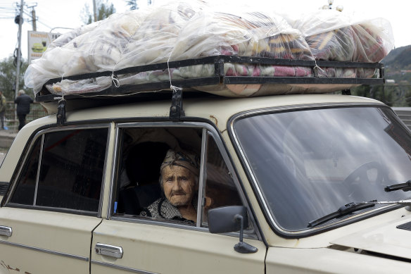 An ethnic Armenian from Nagorno-Karabakh sits in an old Soviet style car as she flees in Armenia’s Goris in Syunik region.