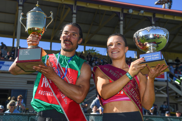 Edward Ware (left) and Hayley Orman hold their trophies after winning their races during the 139th running of the Stawell Gift at Central Park.