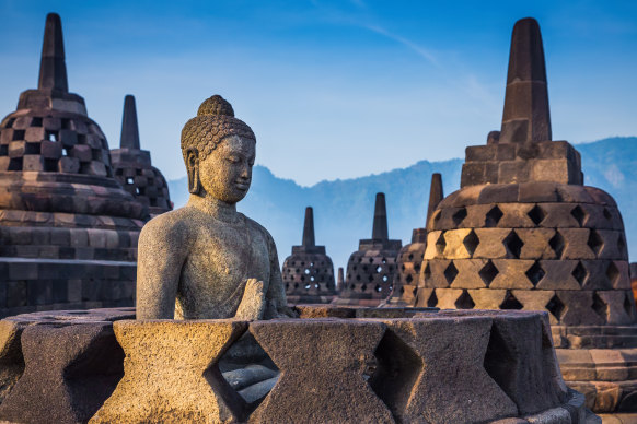 Buddha statue and stupa at Borobudur temple, Java, Indonesia. 