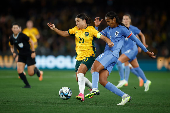 Australia’s Sam Kerr and France’s Wendie Renard compete for the ball.