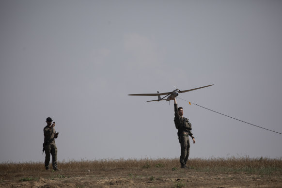 Israeli soldiers lift a drone near the border with the Gaza Strip in April.