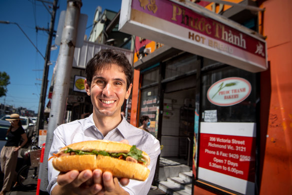 Philip Mallis with a banh mi roll at the Phuoc Thanh bakery in Richmond.