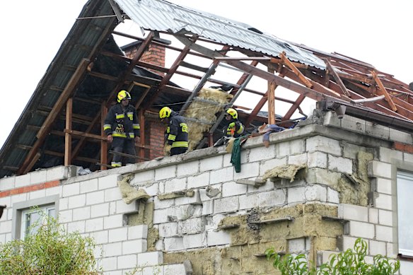 Polish firefighters inspect a house which was  damaged by multiple Russian drone strikes in Wyryki.