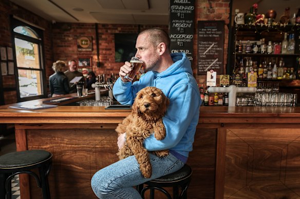 Neil Spark, owner of the Rose Hotel, with his dog Bailey. Yarra City threatened Spark with a fine for having a dog in the bar. 