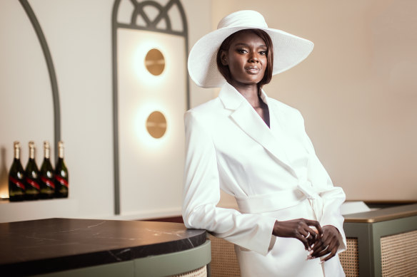 Supermodel Duckie Thot in the Mumm marquee wearing a suit from Michael Lo Sordo and Nerida Winter hat for Derby Day.