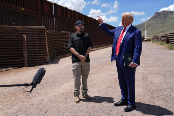 Donald Trump listens to Paul Perez, president of the National Border Patrol Council, as he tours the southern border in Arizona. 