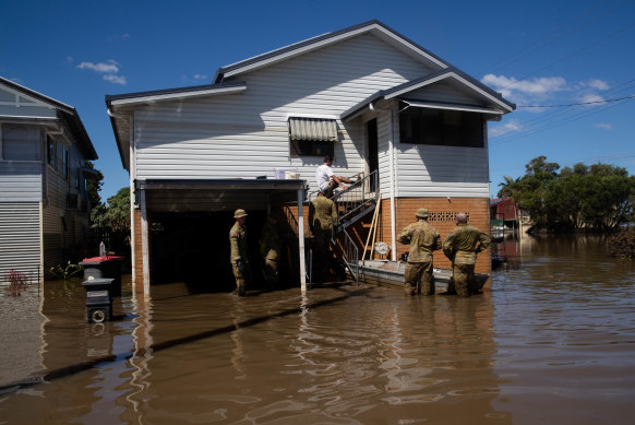 Members of the ADF join community volunteers to clear the house of elderly couple, Gail and Bill Ferrier, in Woodburn in the Northern Rivers region of NSW.