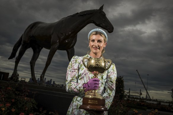 Jamie Kah poses with the Melbourne Cup ahead of her second ride in the race.