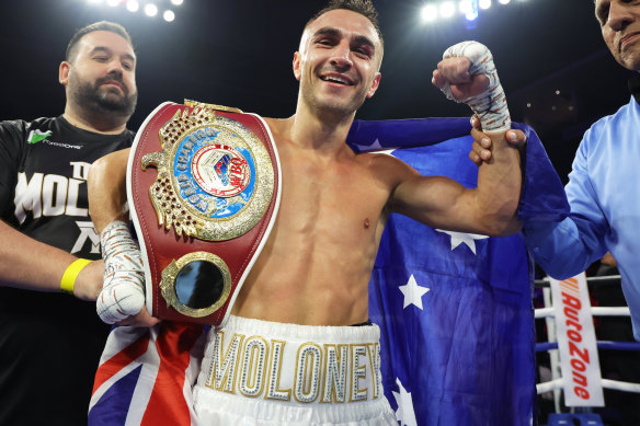 Jason Moloney celebrates with the belt after his win on points.