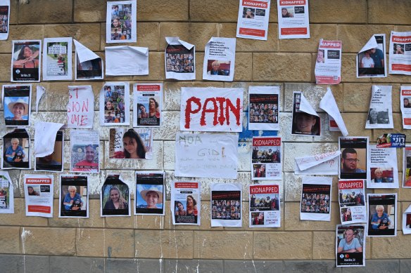 Posters of the faces of Israeli hostages taken by Hamas on a wall in Tel Aviv.