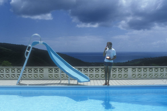 AIR founder and Beatles producer George Martin takes a call by the pool at his dream studio.