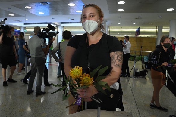 Emma Arzoumanian was among passengers given posies of Australian native flowers and gum leaves as they arrived at Sydney International Airport on Monday morning.