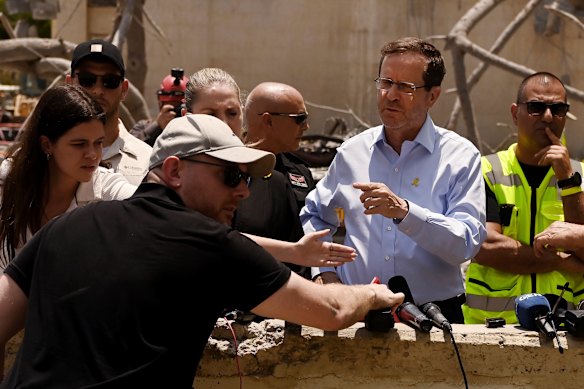 Herzog at a destroyed apartment building that was hit by an Iranian missile in Beersheba, Israel, in June, killing four people. 