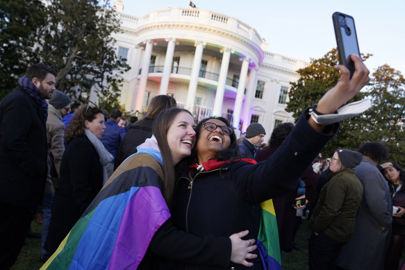 Aparna Shrivastava, right, with her partner Shelby Teeter after President Joe Biden signed the bill into law on the South Lawn of the White House in Washington.