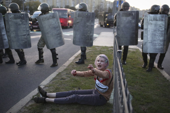A woman reacts in front of police line during a rally in Minsk, Belarus, last week.