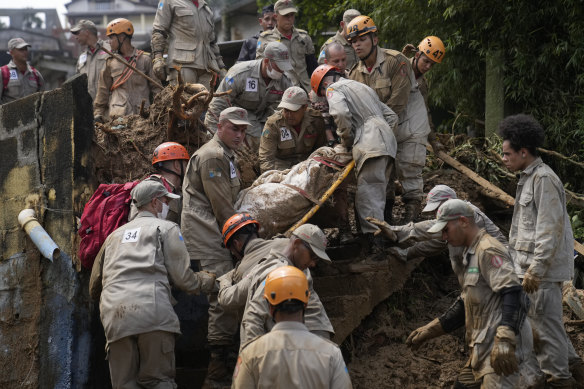 Rescue workers remove the body of a mudslide victim in Petropolis, Brazil.