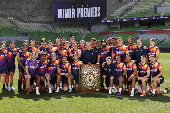 Melbourne Storm coach Craig Bellamy and Storm players pose for a photo with the JJ Giltinan Shield on Wednesday.