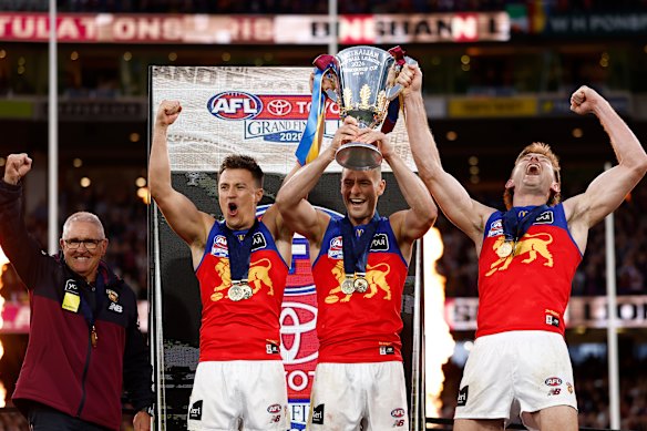 Brisbane Lions coach Chris Fagan and co-captains Hugh McCluggage, Josh Dunkley and Harris Andrews with the premiership cup.