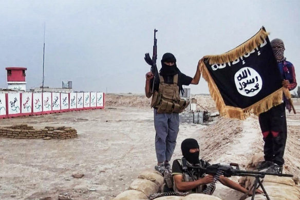 Islamic State fighters pose with a Jihadist flag in northern Iraq.