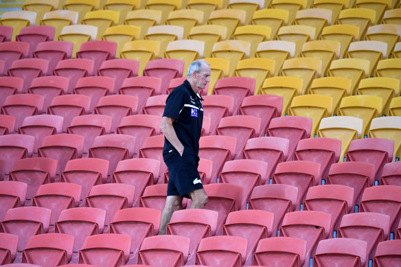 Rabbitohs coach Wayne Bennett walks through an empty grandstand at Suncorp Stadium on full-time against Brisbane last week. 