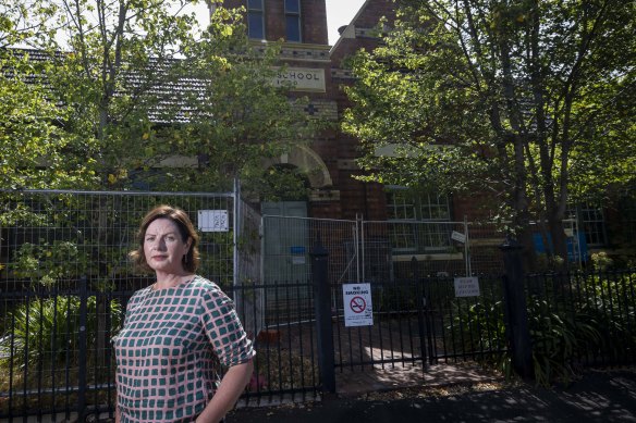 Parent Sophie Bryant outside a building at Fitzroy North Primary School, where slate roof tiles are at risk of falling.