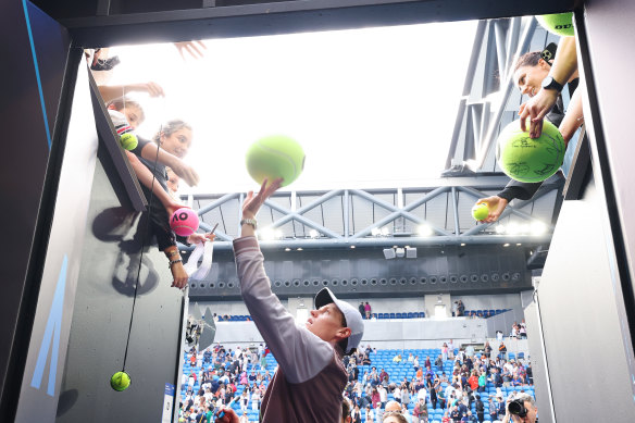 Jannik Sinner signs some Australian Open merchandise.