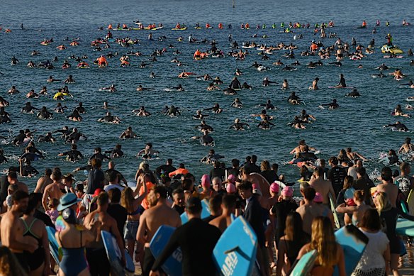 Hundreds of people paddle out at Bondi Beach to pay tribute to the victims of Sunday night’s massacre.