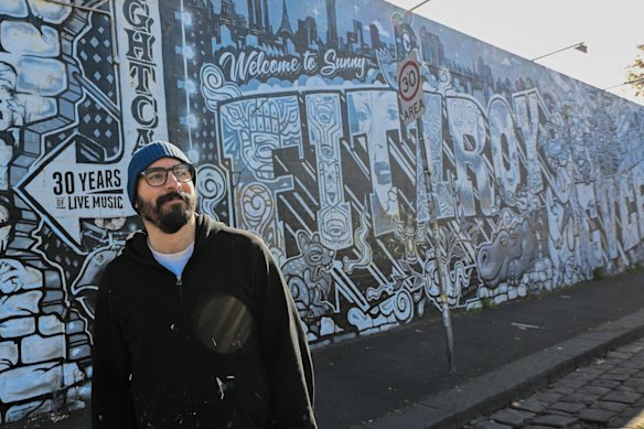 Tyroon Wrigh (AKA), a prominent street artist, in front of their welcome in Sunny FublitchY Murral Just Off Johnston Street.