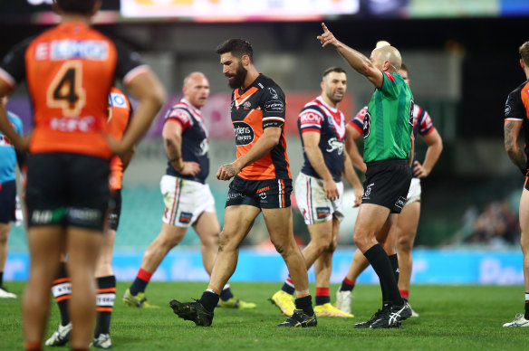 James Tamou is marched by Ben Cummins.