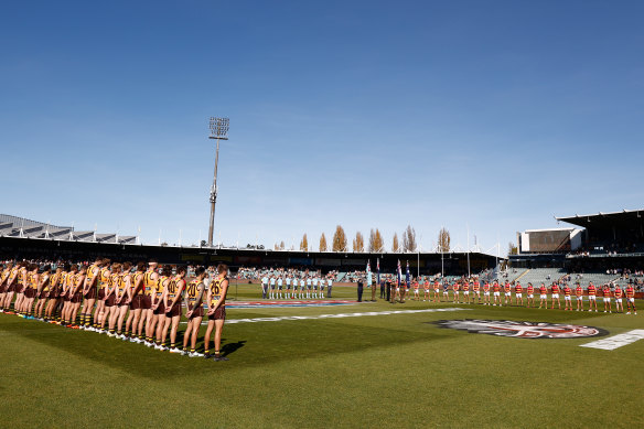 Hawthorn and Adelaide players line up during a ceremony ahead of Anzac Day before their clash at UTAS Stadium on Sunday.