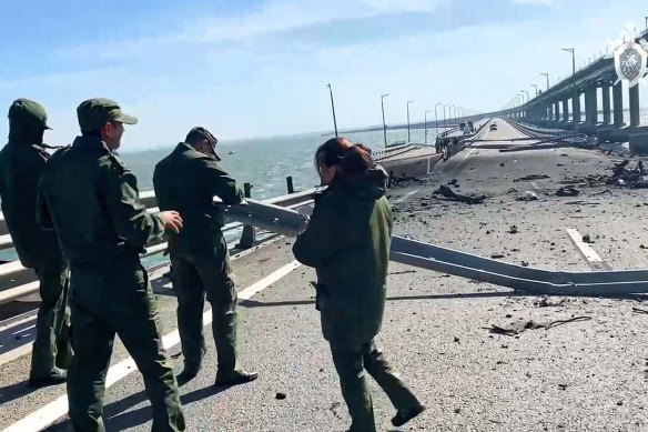 The Russian Investigative Committee at the scene of a damaged part of the Kerch Bridge.