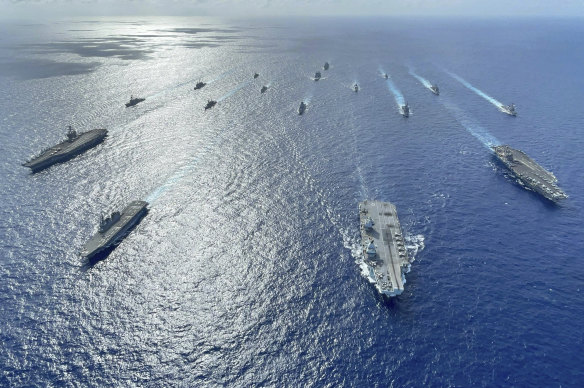 Japanese destroyers with US and British carriers pictured during operations in the Philippine Sea in 2021.