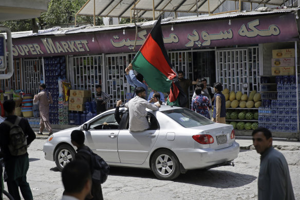 Afghans waved black, red and green banners in honour of the Afghan flag in Kabul and several other cities in defiance of the Taliban.