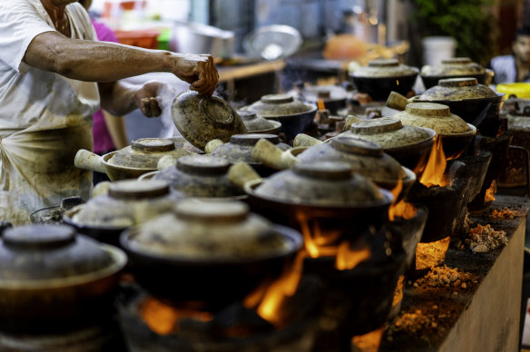 Clay pot chicken rice on the burners at a Kuala Lumpur night market.