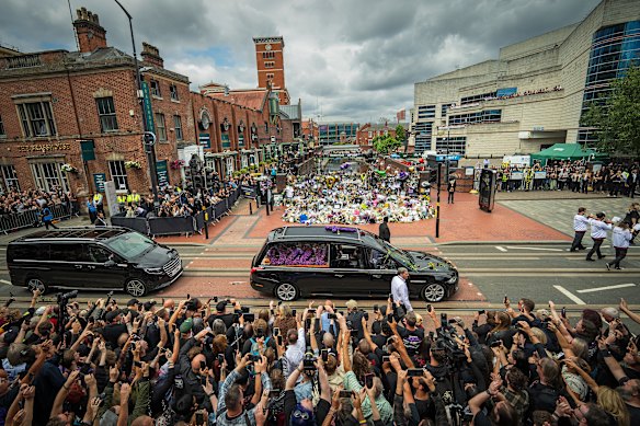Osbourne’s funeral cortege makes it way through the streets of Birmingham past the Black Sabbath Bench in Birmingham, England.
