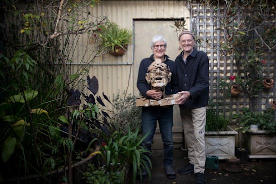 Rod Holdaway (left) holds a bust he created of Merrick Fry.