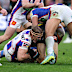Nathan Cleary of the Panthers is tackled by Phoenix Crossland of the Knights.