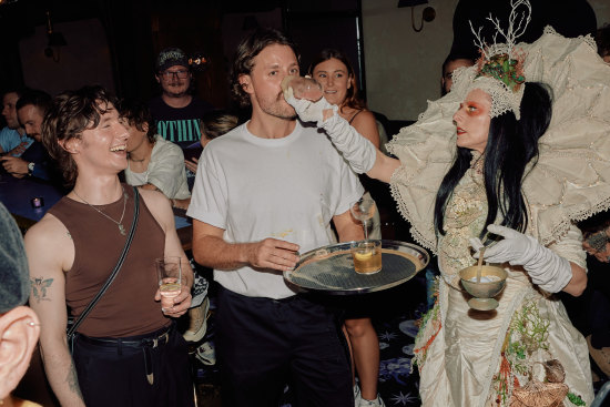 A roaming performer helping a customer with their drink at Pleasure Club, Newtown.