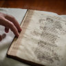 Cat ruins master’s 17th century book with inky paw prints