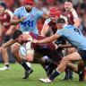 Liam Wright is tackled of the Reds