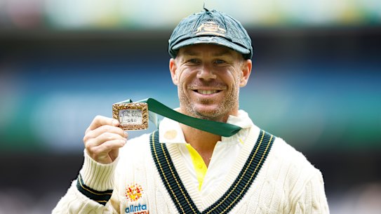 David Warner holds the Mullagh Medal after being awarded player of the match at the MCG.