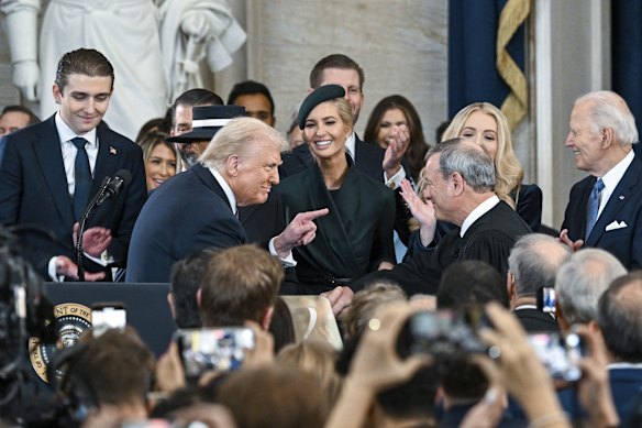 President Donald Trump (left) points to Supreme Court Chief Justice John Roberts after taking the oath of office.