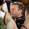 Sam Mitchell addresses his players during the clash with the Saints at Marvel Stadium.