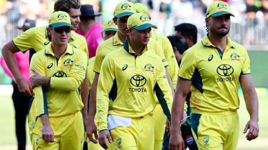 Australian players walk off the pitch after their loss to Pakistan.