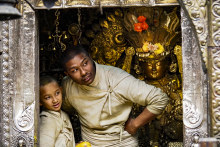 Child and adult priests at Kwa Bahal, or Golden Temple, Patan.