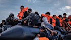 Migrant families wade into the sea in an attempt to board a small boat on in Gravelines, France.